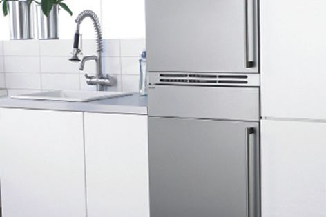 The washing machine and tumble dryer are integrated behind closed doors complementing the cabinetry.