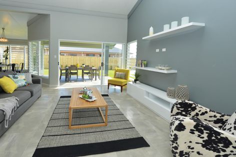 The InsulLiving display house features double-height raked ceilings in open-plan living areas, and louvre windows.