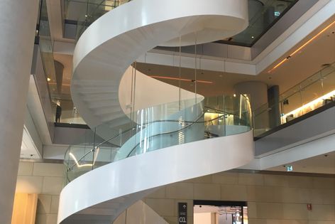 The stair in the lobby of Barangaroo tower T2 features curved heat-strengthened laminated glass panels by Bent and Curved Glass.